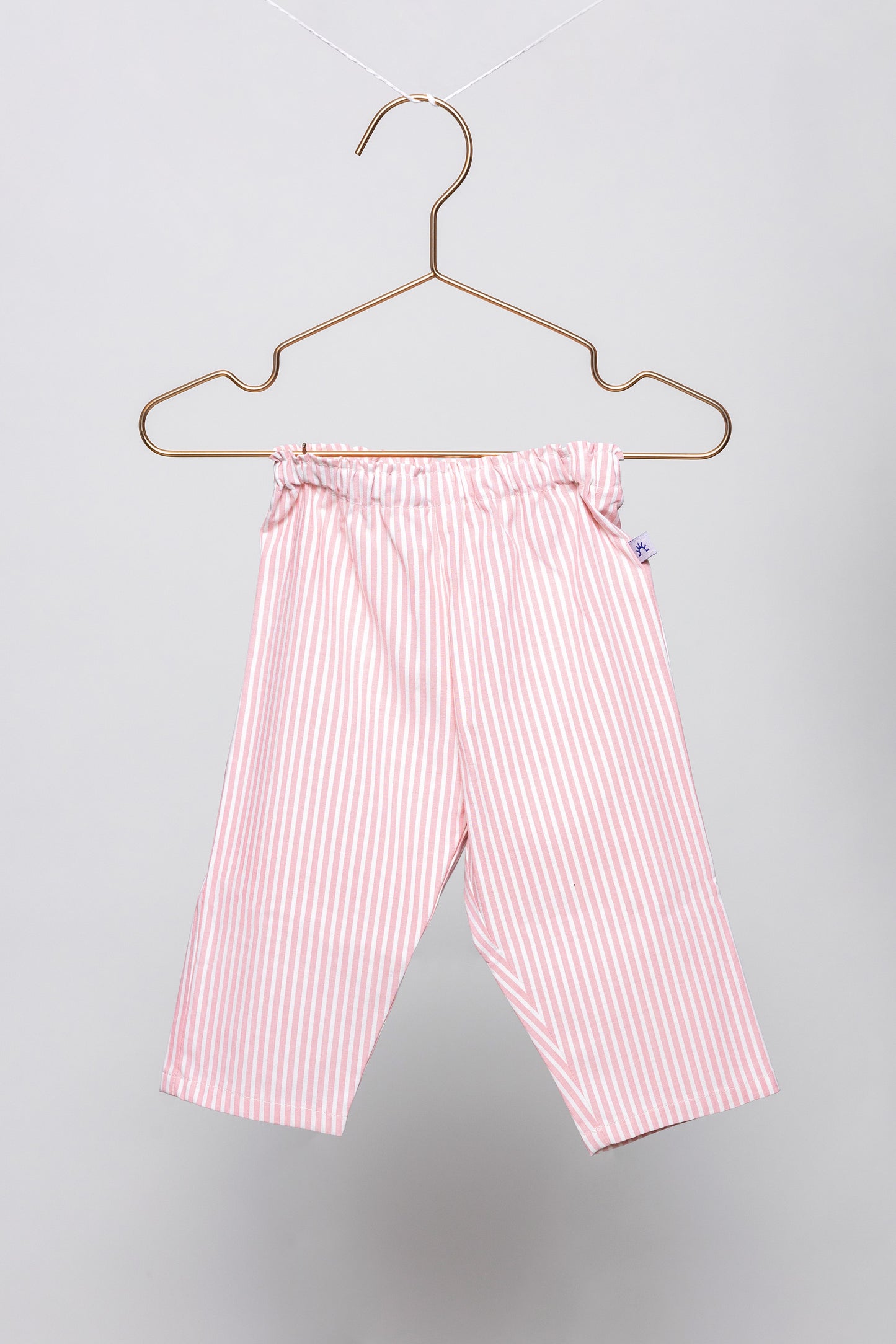 front view of pink and white pinstripes pajama pants, good morning monsters woven pajamas, loungewear, sleepwear, loose-fitting pajamas, boys, girls, baby, unisex