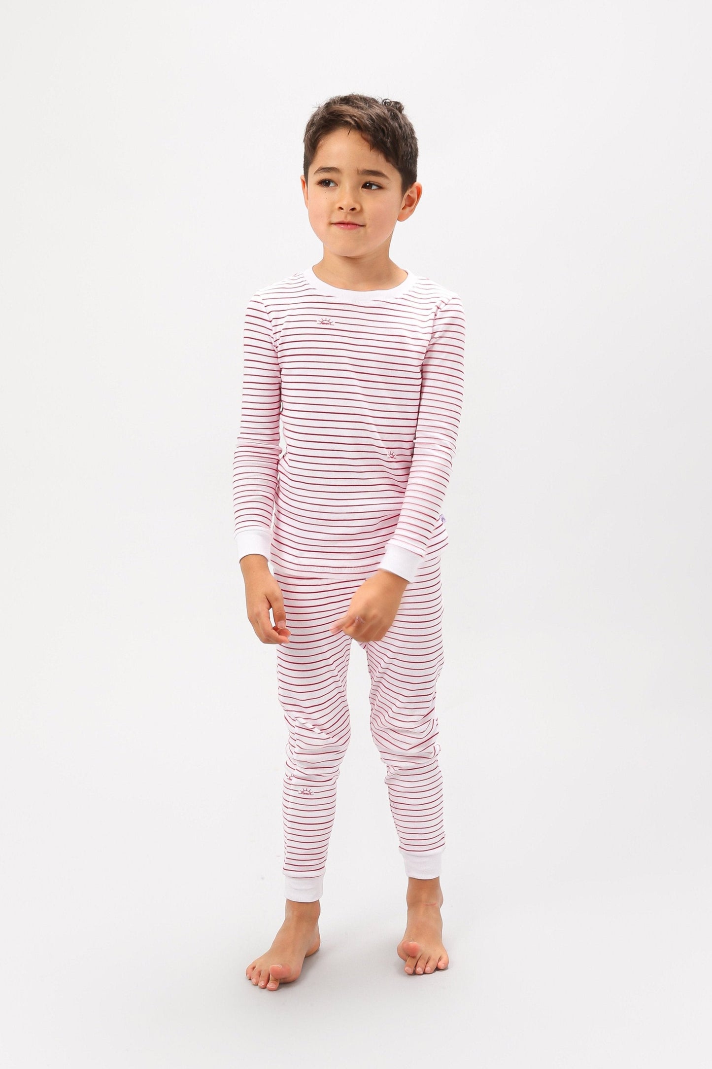 Front view of model wearing red stripes pajama set.
Pajamas are white, lightweight fabric with playful red stripes throughout (along with our GMM logo sprinkled in). Pajamas are long-sleeved and made from GOTS certified, 100% organic cotton.
good morning monsters pajamas, loungewear, sleepwear, pajamas, boys, girls, baby, unisex
