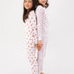 2 models standing back to back (one model wearing unicorn print PJ set, other model wearing tulips print PJ set).  
Pajamas are white fabric with vibrant, colorful prints.  Pajamas are long-sleeved and made from GOTS certified, 100% organic cotton.
good morning monsters pajamas, loungewear, sleepwear, pajamas, boys, girls, baby, unisex
