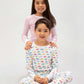 2 models sitting, one in a brightly colorful vehicles print, the other in red stripes prints.
Pajamas are white, lightweight, fabric with vibrant, colorful prints.  Pajamas are long-sleeved and made from  GOTS certified, 100% organic cotton.
good morning monsters pajamas, loungewear, sleepwear, pajamas, boys, girls, baby, unisex