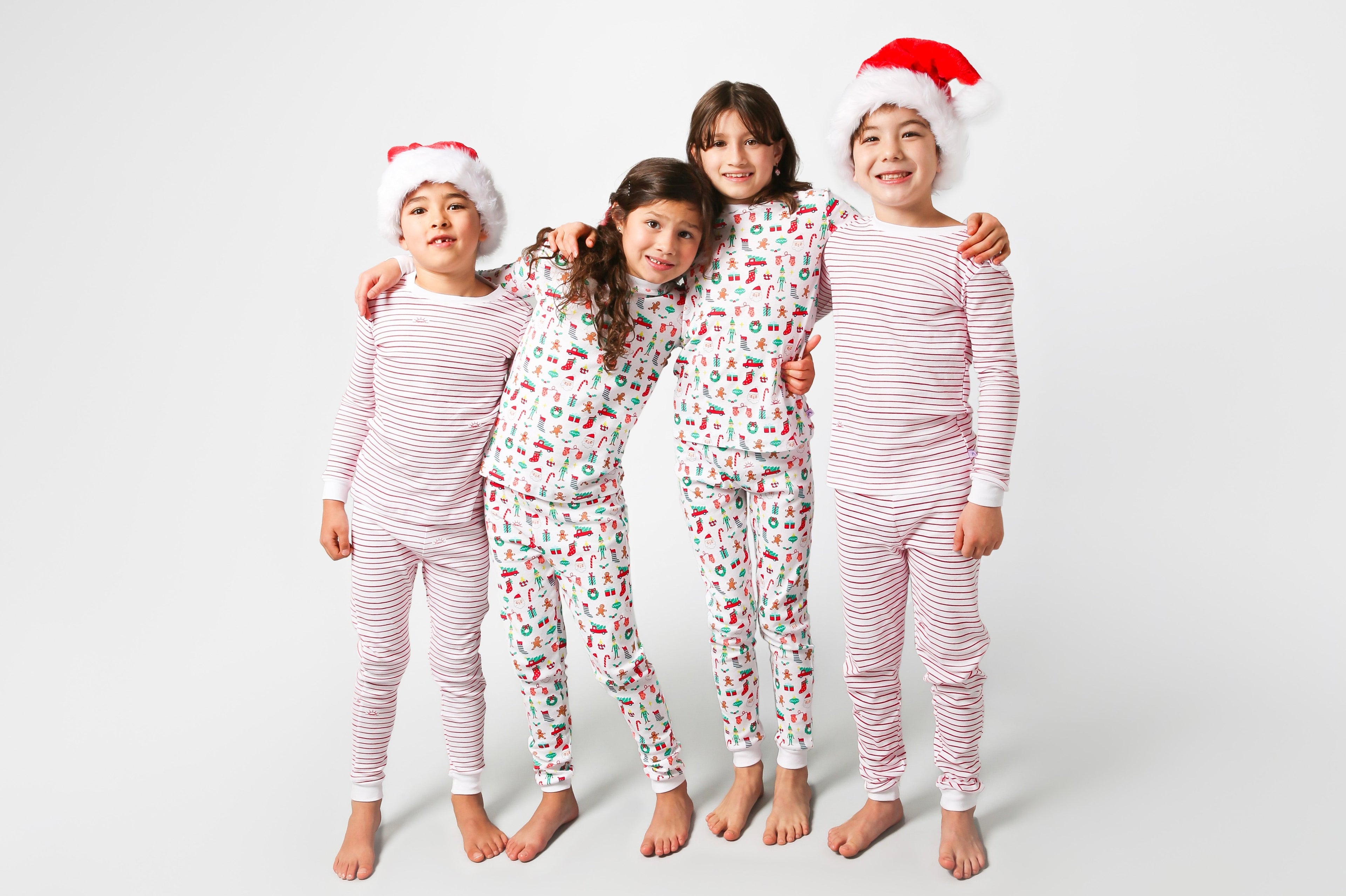 4 models posing, 2 with Santa hats
2 models wearing Christmas, festive, Santa, Elves, Classic Christmas, Holiday, Ornaments, Stockings, Gingerbread, Red Trucks pajama set / 2 models wearing hand drawn red stripes pajama set  
Pajamas are white, lightweight fabric with a vibrant Christmas print.   Pajamas are long-sleeved and made from GOTS certified, 100% organic cotton.
good morning monsters pajamas, loungewear, sleepwear, pajamas, boys, girls, baby, unisex