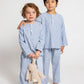 two models wearing blue and white pinstripe pajamas (one model is holding jellycat doll), good morning monsters woven pajamas, loungewear, sleepwear, loose-fitting pajamas, boys, girls, baby, unisex