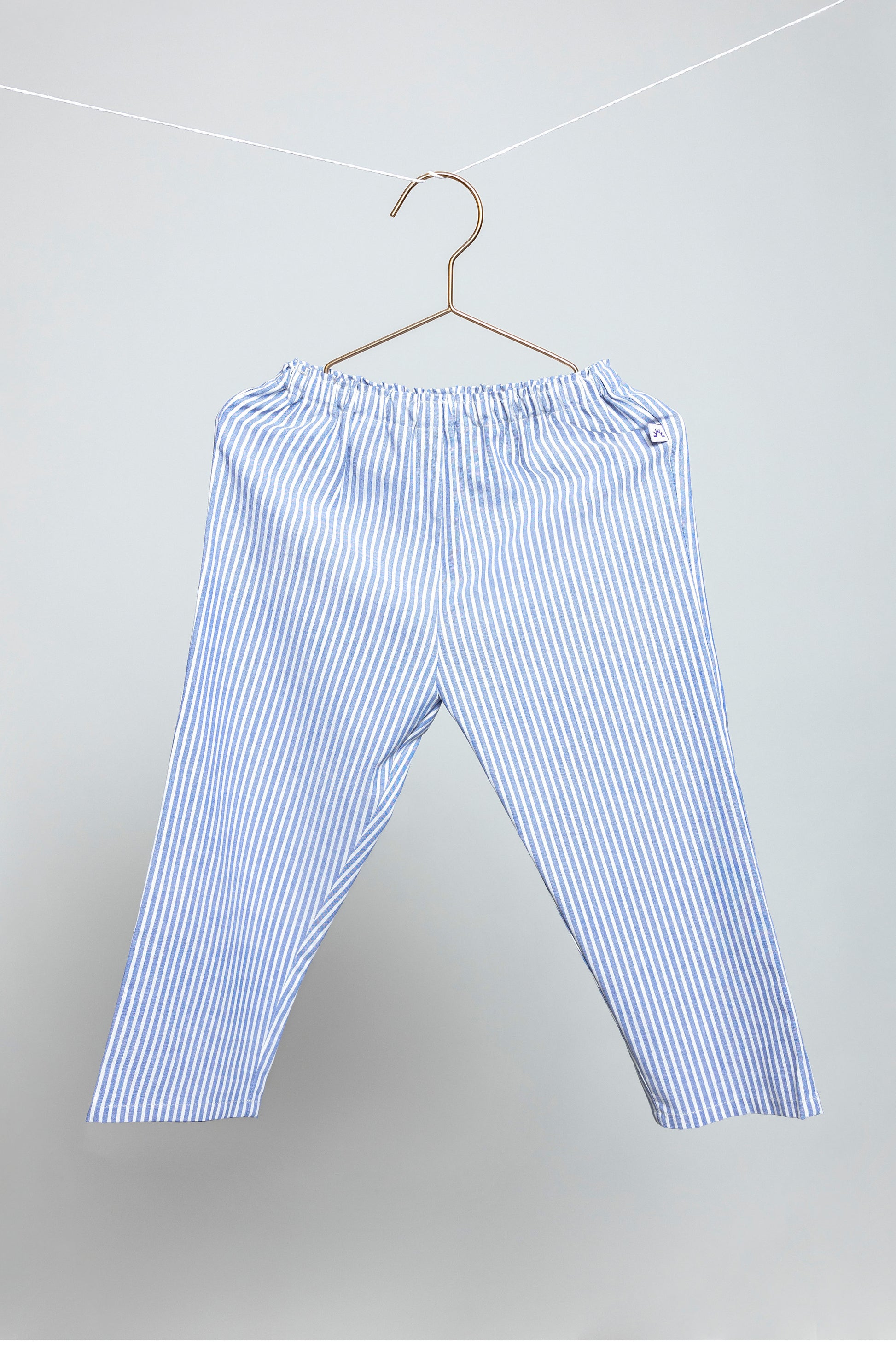 front view of blue and white pinstripes pajama pants, good morning monsters woven pajamas, loungewear, sleepwear, loose-fitting pajamas, boys, girls, baby, unisex