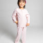 model wearing pink and white pinstripe pajamas, good morning monsters woven pajamas, loungewear, sleepwear, loose-fitting pajamas, boys, girls, baby, unisex