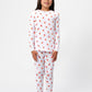 Front view of model wearing unicorn pajama set.  
Pajamas are white, lightweight  fabric with a vibrant, colorful unicorn print.  Pajamas are long-sleeved and made from GOTS certified, 100% organic cotton.
good morning monsters pajamas, loungewear, sleepwear, pajamas, boys, girls, baby, unisex