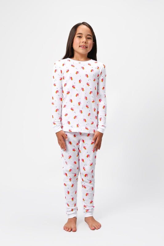 Front view of model wearing unicorn pajama set.  
Pajamas are white, lightweight  fabric with a vibrant, colorful unicorn print.  Pajamas are long-sleeved and made from GOTS certified, 100% organic cotton.
good morning monsters pajamas, loungewear, sleepwear, pajamas, boys, girls, baby, unisex