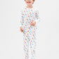 Front view of model wearing vehicles pajama set.  
Pajamas are white, lightweight fabric with a vibrant, colorful vehicles print with cars, jeeps, trucks, and buses.  Pajamas are long-sleeved and made from 100% GOTS certified organic cotton.
good morning monsters pajamas, loungewear, sleepwear, pajamas, boys, girls, baby, unisex