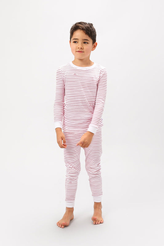 Front view of model wearing red stripes pajama set.  
Pajamas are white, lightweight  fabric with playful red stripes throughout (along with our GMM logo sprinkled in).  Pajamas are long-sleeved and made from GOTS certified, 100% organic cotton.
good morning monsters pajamas, loungewear, sleepwear, pajamas, boys, girls, baby, unisex