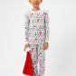 Front view of model with Santa hat, wearing Christmas, festive, Santa, Elves, Classic Christmas, Holiday, Ornaments, Stockings, Gingerbread, Red Trucks pajama set.  
Pajamas are white, lightweight fabric with a vibrant Christmas print.   Pajamas are long-sleeved and made from GOTS certified, 100% organic cotton.
good morning monsters pajamas, loungewear, sleepwear, pajamas, boys, girls, baby, unisex