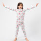 Front view of model arms out posing, wearing Christmas, festive, Santa, Elves, Classic Christmas, Holiday, Ornaments, Stockings, Gingerbread, Red Trucks pajama set.  
Pajamas are white, lightweight fabric with a vibrant Christmas print.   Pajamas are long-sleeved and made from GOTS certified, 100% organic cotton.
good morning monsters pajamas, loungewear, sleepwear, pajamas, boys, girls, baby, unisex