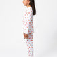 Side view of model wearing unicorn pajama set.  
Pajamas are white, lightweight fabric with a vibrant, colorful unicorn print.  Pajamas are long-sleeved and made from GOTS certified, 100% organic cotton.
good morning monsters pajamas, loungewear, sleepwear, pajamas, boys, girls, baby, unisex